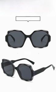 Detailed front and side views of black oversized square bohemian style sunglasses