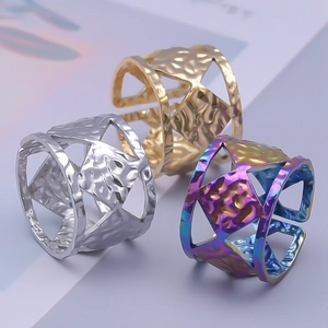 Detailed shot of hammered hollow geometric rings in gold, silver, and rainbow colors