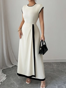 Elegant cream sleeveless maxi dress with black contrast trim and pleated waist detail