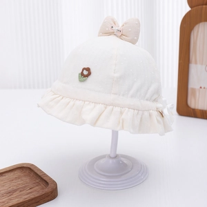 Detail of baby sun hat featuring floral embroidery, polka dot bow and ruffled brim