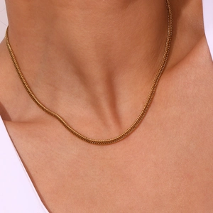 Close-up of 18K gold-plated foxtail chain showing intricate wheat pattern on model