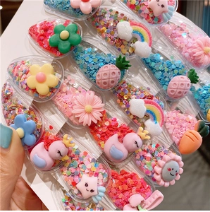 Close-up of glitter-filled fruit and rainbow resin hair clips for toddler girls