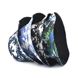 Tropical palm tree print bucket hats for women in blue, black, and green colors