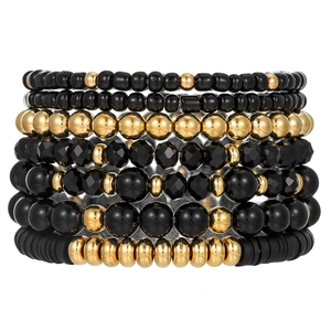 Detailed set of seven black and gold acrylic beaded stretch bracelets in boho style