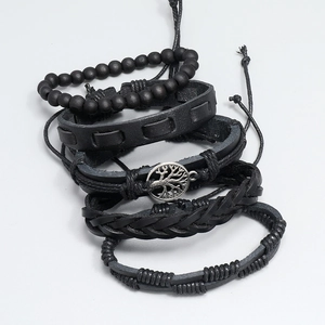 Detail of 4-piece black leather bracelet set featuring Tree of Life charm and wooden beads