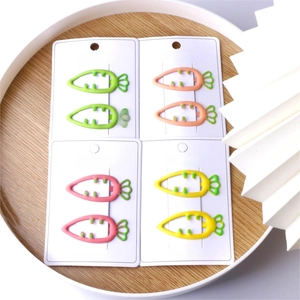 Eight colorful carrot-shaped matte hair clips in green, orange, pink and yellow shades