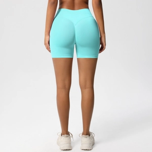 Detail view of seamless high-waist yoga shorts in turquoise with scrunch butt design