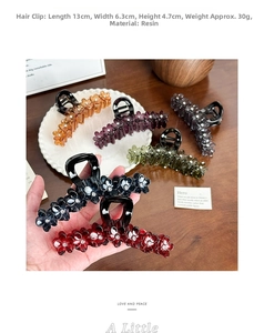 Detailed view of large resin flower hair claw with rhinestones and dimension markings