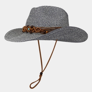 Detail of hand-woven straw hat showing blue texture, ethnic band and turquoise bead