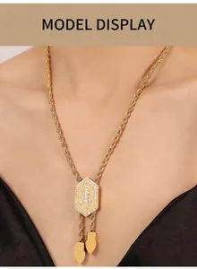 Detail of a vintage-style gold hexagon pendant necklace with diamonds on a twisted chain