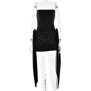 Detail of black strapless mini dress with corset bodice, gold buckle, and elegant draping