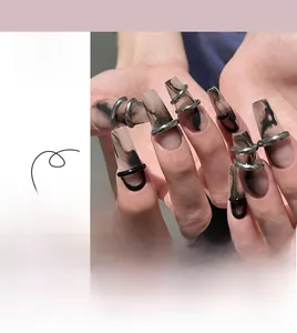 Detail of medium-long matte black ink smudge press-on nails with silver metal ring decor