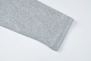 Detail shot of grey knitted cuff with clean stitching on fashionable long pants set