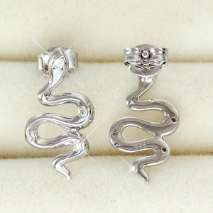 Macro view of S925 sterling silver snake stud earrings with pavé zircon details