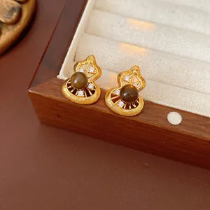 Vintage gold Wu Lou stud earrings with brown tiger eye stone and white zircons