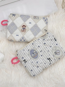 Quilted mini makeup bags with cute teddy bear and carousel patterns on plush background