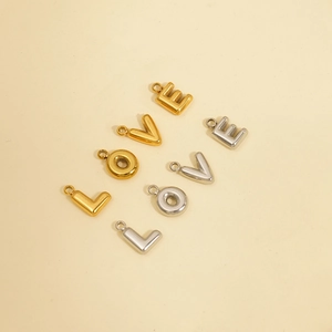 Detail of 18K gold and silver metal bubble letter pendants spelling LOVE for jewelry DIY