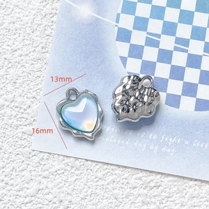 Macro shot of 13mm heart charms with silver frames for DIY jewelry crafts
