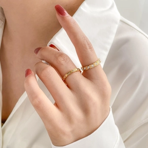 Chic gold ring set with black glaze and sparkling square zircon stones on model hand