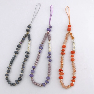 Detailed view of handmade beaded phone charms with glass beads and LOVE letter accents