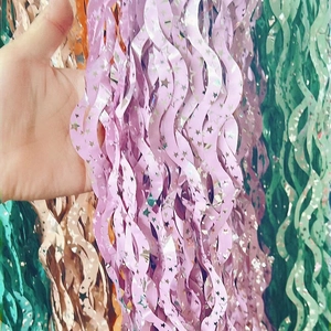 Sparkling wavy foil fringe curtain with stars for party backdrops in pink, gold and green