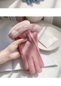 Close-up of pink faux suede winter gloves with thick fur trim and touch screen fingertips