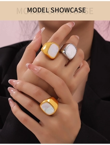 Elegant gold titanium ring with white shell inlay shown on hand for business style