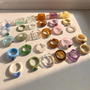 Close-up of colorful resin acrylic rings set with assorted geometric jelly textures