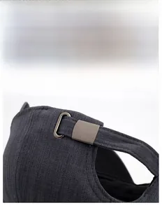 Detail of adjustable metal buckle on dark grey cotton baseball cap for men