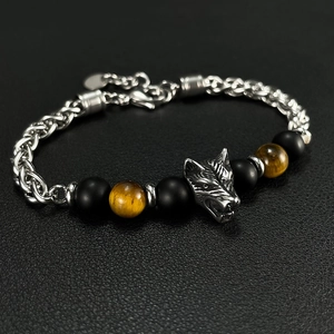 Detail of stainless steel wolf head bracelet with brown tiger eye beads and metal chain