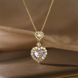 Macro detail of luxury double heart pendant necklace with shimmering crystals on silk