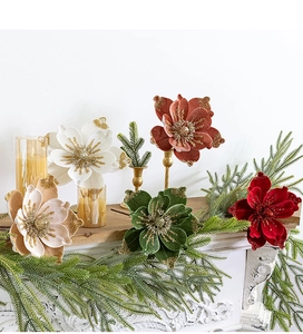 Detailed velvet Christmas flower with gold glitter edges on a holiday mantelpiece