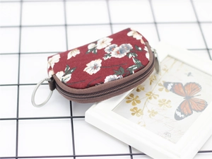 Floral print semi-circle coin purse with burgundy fabric and metal keyring attachment