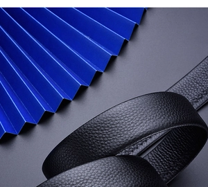 Close-up of premium black pebble grain leather belt showing detailed stitching and texture