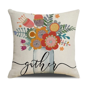 Close-up of beige linen pillow cover featuring colorful floral art and Gather text
