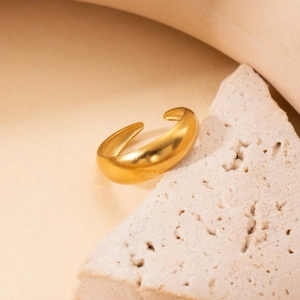 Minimalist 18k gold plated titanium steel open ring displayed on a natural stone base