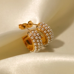 18K gold plated stainless steel C-shaped hoop earrings with white pearls on silk background