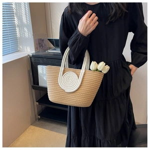 Detail of contrast cotton rope woven tote bag with round white handle and tulip decor