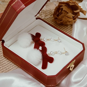 Red velvet bow earrings with fur balls and pearls displayed in a vintage jewelry box