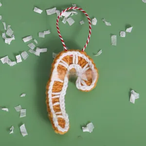 Handmade crochet Christmas candy cane ornament with yellow and white knit patterns