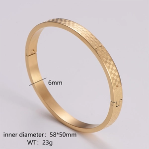 Macro view of golden stainless steel bracelet detailing checkered texture and 6mm width