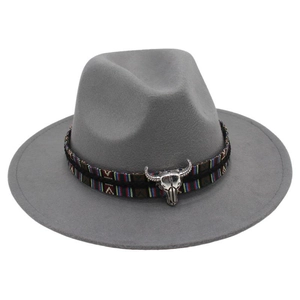 Close-up of ethnic woven band with silver bull head charm on dark grey wool felt fedora