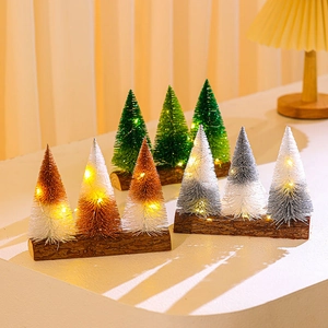 Miniature glitter Christmas trees on wood bases with warm LED string lights for decor