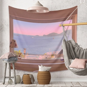 Detail of bohemian tapestry featuring a dreamy sunset ocean view through a window frame