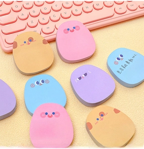 Detailed view of colorful egg-shaped sticky notes with cute expressions on a desk