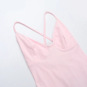 Detail of pink V-neck jumpsuit featuring slim straps and a sexy cross backless design
