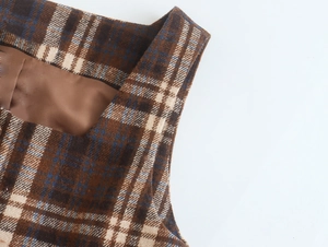Detail of retro plaid dress neckline showing brown and blue tweed fabric texture