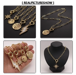 Detail of 18K gold plated necklaces featuring star and moon charms on paperclip chains