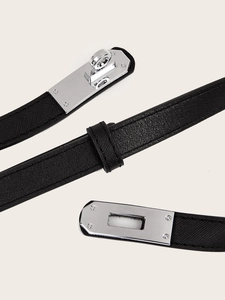 Macro detail of black leather belt with silver buckle and fine cross-grain texture