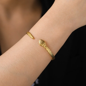Adjustable gold snake head bangle in titanium steel with detailed scale texture